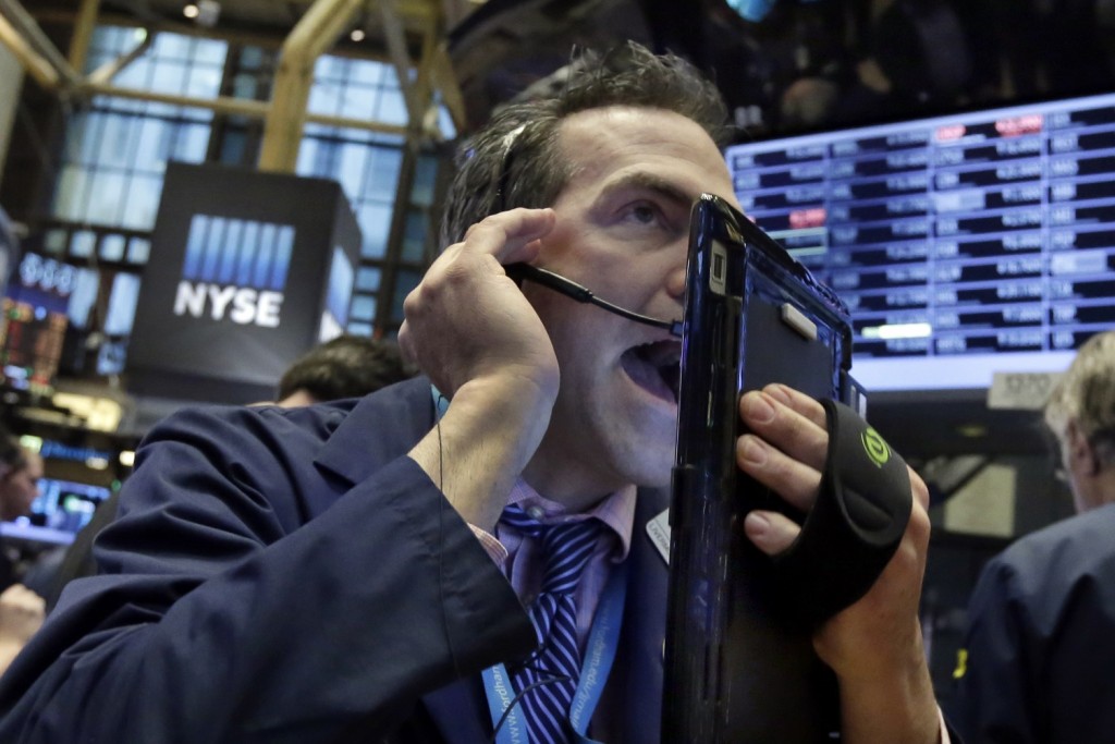 Trader Gregory Rowe works on the floor of the New York Stock Exchange, Wednesday, Jan. 20, 2016. Energy stocks are leading another sell-off on Wall Street as the price of oil continues to plunge. (AP Photo/Richard Drew)