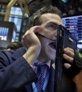 Trader Gregory Rowe works on the floor of the New York Stock Exchange, Wednesday, Jan. 20, 2016. Energy stocks are leading another sell-off on Wall Street as the price of oil continues to plunge. (AP Photo/Richard Drew)