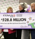 Rebecca Hargrove, second from right, president and CEO of the Tennessee Lottery, presents a ceremonial check to John Robinson, right; his wife, Lisa, second from left; and their daughter, Tiffany, left; after the Robinson's winning Powerball ticket was authenticated at the Tennessee Lottery headquarters Friday, Jan. 15, 2016, in Nashville, Tenn. The ticket was one of three winning tickets in the $1.6 billion jackpot drawing. (AP Photo/Mark Humphrey)