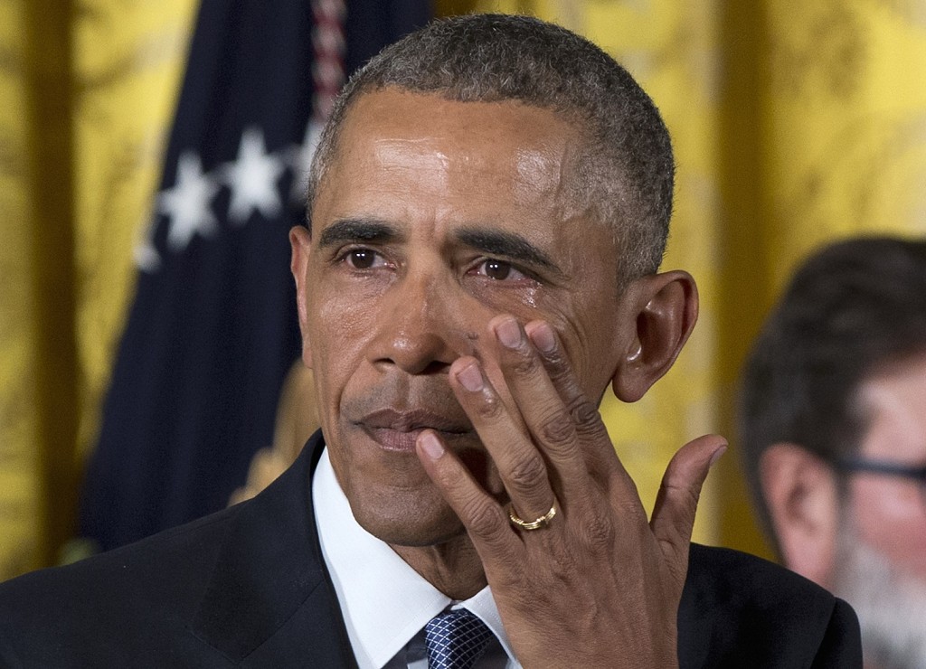 President Barack Obama wipes away tears from his eyes as he speaks in the East Room of the White House in Washington, Tuesday, Jan. 5, 2016, about steps his administration is taking to reduce gun violence. Also on stage are stakeholders, and individuals whose lives have been impacted by the gun violence. (AP Photo/Carolyn Kaster)