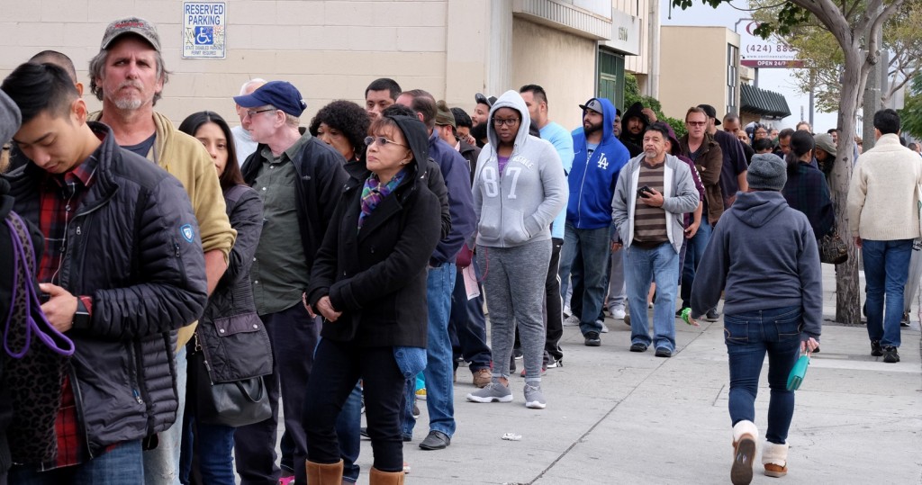 Customers wait in line at the Blue Bird Liquor Store to buy Powerball lottery tickets in Hawthorne, Calif. on Saturday, Jan. 9, 2016. Ticket sales for the multi-state Powerball lottery soared Saturday, in the largest jackpot in U.S. history which grew to $900 million just hours before Saturday night's drawing. (AP Photo/Richard Vogel)