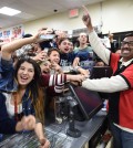 7-Eleven store clerk M. Faroqui celebrates with customers after learning the store sold a winning Powerball ticket on Wednesday, Jan. 13, 2016 in Chino Hills, Calif. One winning ticket was sold at the store located in suburban Los Angeles said Alex Traverso, a spokesman for California lottery. The identity of the winner is not yet known. (Will Lester/The Sun via AP)