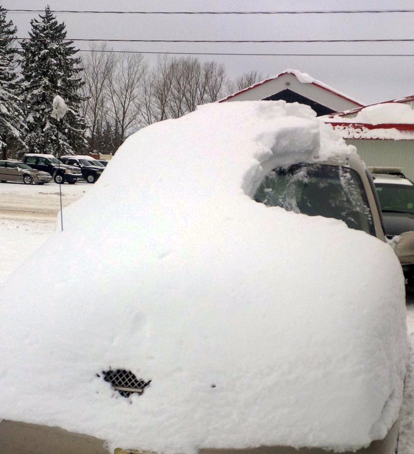 This Tuesday, Jan. 19, 2016 photo provided by the Ontario Provincial Police shows a snow covered vehicle in Brussels, Ontario. An 80-year-old man has been charged after driving the car that was almost completely covered in snow with only the driver’s side windshield visible. (Sgt. Russell Nesbitt/Ontario Provincial Police via AP)