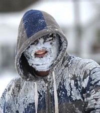 Michael Rainey got his face full of snow after tubing down the hill along Broad Street in Bristol, Tennessee on Friday, Jan. 22, 2016. The morning snow added to the snow from the Wednesday snow storm that came through the area. (Earl Neikirk/Bristol Herald Courier via AP)