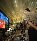 Guests watch an electronic stock board showing the first day trading of the year figures during a ceremony marking the start of this year's trading in Tokyo, Monday, Jan. 4, 2016. (AP Photo/Eugene Hoshiko)