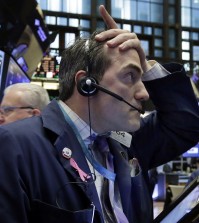 Trader Gregory Rowe works on the floor of the New York Stock Exchange, Wednesday, Jan. 6, 2016. Stocks are opening lower as investors fret about signs of belligerence in North Korea and more weakening of China's economy. (AP Photo/Richard Drew)