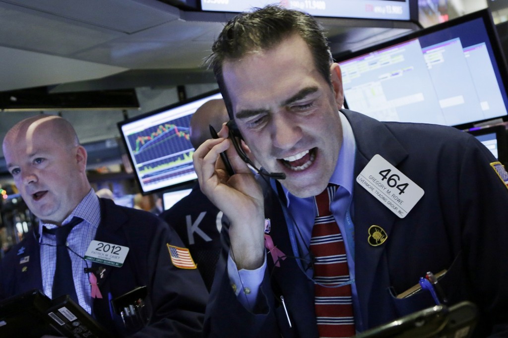 Stock trader Gregory Rowe works at the New York Stock Exchange, Friday, Jan. 15, 2016. (AP Photo/Mark Lennihan)