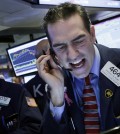 Stock trader Gregory Rowe works at the New York Stock Exchange, Friday, Jan. 15, 2016. (AP Photo/Mark Lennihan)