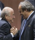 FILE - In this Friday, May 29, 2015 file photo, FIFA president Sepp Blatter is greeted by UEFA President Michel Platini, right, after Blatters re-election as president at the Hallenstadion in Zurich, Switzerland. Sepp Blatter and Michel Platini have been banned for 8 years, the FIFA ethics committee said Monday, Dec. 21, 2015. (Patrick B. Kraemer/Keystone via AP, File)