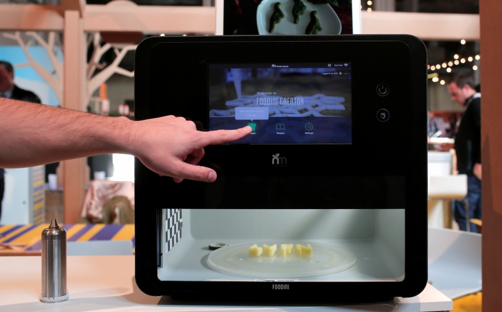 A man touches the screen of a 3-D food printer during the Mobile World Congress wireless show in Barcelona, Spain, Tuesday, Feb. 23, 2016. Natural Machines co-founder Lynette Kucsma insisted her company hadn’t replicated Star Trek’s “food synthesizer” that made munchies appear at Captain Kirk’s mere command. But they sure have come pretty close with their 3-D food printer. (AP Photo/Manu Fernandez)