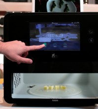 A man touches the screen of a 3-D food printer during the Mobile World Congress wireless show in Barcelona, Spain, Tuesday, Feb. 23, 2016. Natural Machines co-founder Lynette Kucsma insisted her company hadn’t replicated Star Trek’s “food synthesizer” that made munchies appear at Captain Kirk’s mere command. But they sure have come pretty close with their 3-D food printer. (AP Photo/Manu Fernandez)