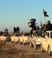 FILE - In this undated file photo released online in the summer of 2014 on a militant social media account, which has been verified and is consistent with other AP reporting, militants of the Islamic State group hold up their weapons and wave its flags on their vehicles in a convoy on a road leading to Iraq, in Raqqa, Syria. The extremist group that once bragged about minting its own currency is now accepting only U.S. dollars in Raqqa, slashing salaries across the board and imposing “exit fees” for those trying to leave its domain. (Militant photo via AP, File)