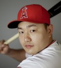 FILE - In this Feb. 26, 2016, file photo,  Ji-Man Choi of the Los Angeles Angels baseball team, poses in Tempe, Ariz. Ji-Man Choi didn't become a swtich-hitter until midway through last season. His remarkable mid-career adjustment could make him part of the Los Angeles Angels' patch for their hole in left field.  (AP Photo/Chris Carlson, File)