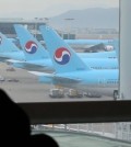 Korean Air Lines planes are visible outside a window at a departure gate of Incheon International Airport, west of Seoul, on Feb. 19, 2016. Unionized pilots of South Korea's No. 1 carrier voted for a strike on the day which, if carried out, would be the first in 11 years. The pilots demanded a 37 percent wage hike, while the management offered a 1.9 percent increase. The union said it is not planning on an immediate walkout, but will gradually raise the strike participation level depending on how talks proceed with the management. (Yonhap)