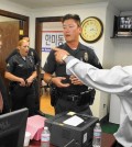 With police officers looking on, Sung Hoon Yoon, left, and Sung Woong Kim argue in the offices of the Korean American United Foundation in 2014. Yoon and Kim each claim to be the legitimate leader of the foundation. (Sang H. Park / The Korea Times Los Angeles)