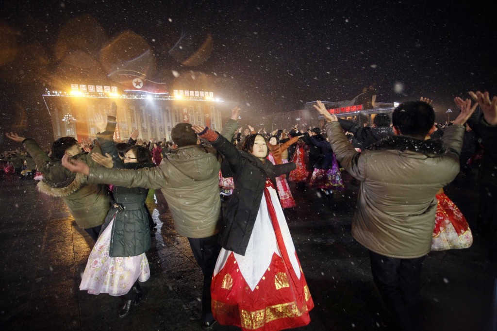 North Koreans dance on the Kim Il Sung Square to celebrate a satellite launch Monday, Feb. 8, 2016, in Pyongyang, North Korea. People in Pyongyang danced and watched fireworks the day after a rocket launch that has been strongly condemned by many countries around the world. (AP Photo/Jon Chol Jin)