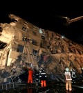 Rescue workers search a toppled building after an earthquake in Tainan, Taiwan, Saturday, Feb. 6, 2016. The 6.4-magnitude earthquake struck southern Taiwan early Saturday, toppling at least one high-rise residential building and trapping people inside. Firefighters rushed to pull out survivors. (AP Photo)