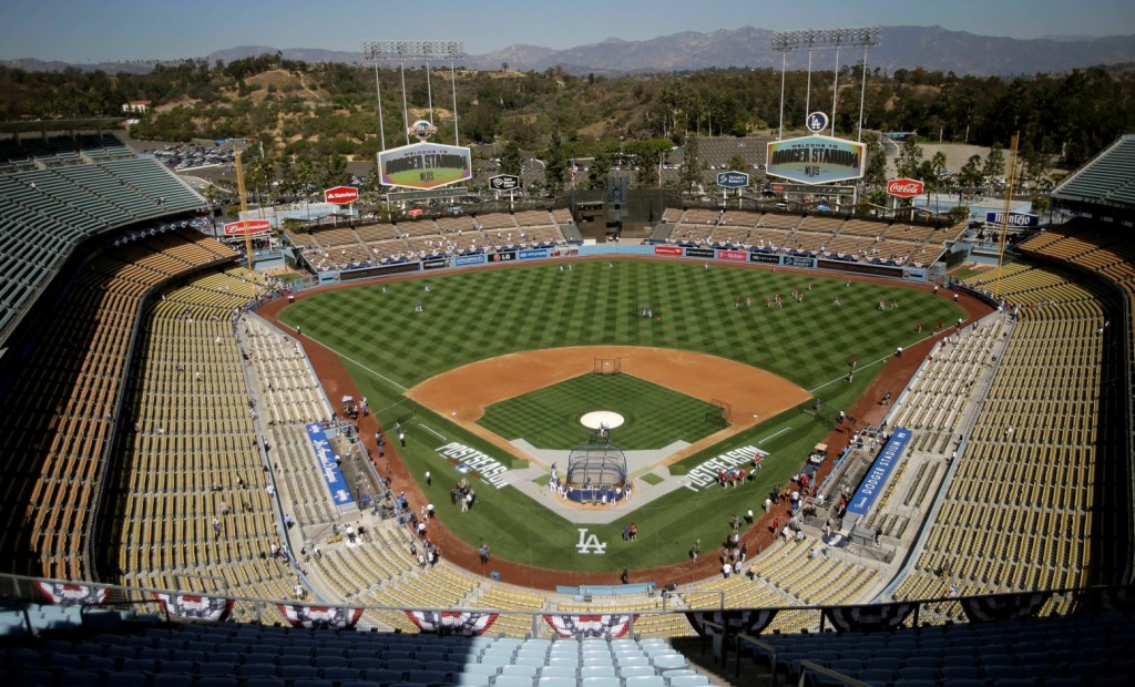 FILE - In this Oct. 3, 2014, file photo, the Los Angeles Dodgers and the St. Louis Cardinals gather on the field for batting practice at Dodger Stadium before Game 1 of baseball's NL Division Series in Los Angeles. The Los Angeles Dodgers have signed a multi-year deal to book more high-end concerts at their venerable baseball stadium. The deal between the team and Oak View Group was announced Tuesday, Feb. 16, 2016. (AP Photo/Alex Gallardo, File)