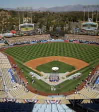 FILE - In this Oct. 3, 2014, file photo, the Los Angeles Dodgers and the St. Louis Cardinals gather on the field for batting practice at Dodger Stadium before Game 1 of baseball's NL Division Series in Los Angeles. The Los Angeles Dodgers have signed a multi-year deal to book more high-end concerts at their venerable baseball stadium. The deal between the team and Oak View Group was announced Tuesday, Feb. 16, 2016. (AP Photo/Alex Gallardo, File)