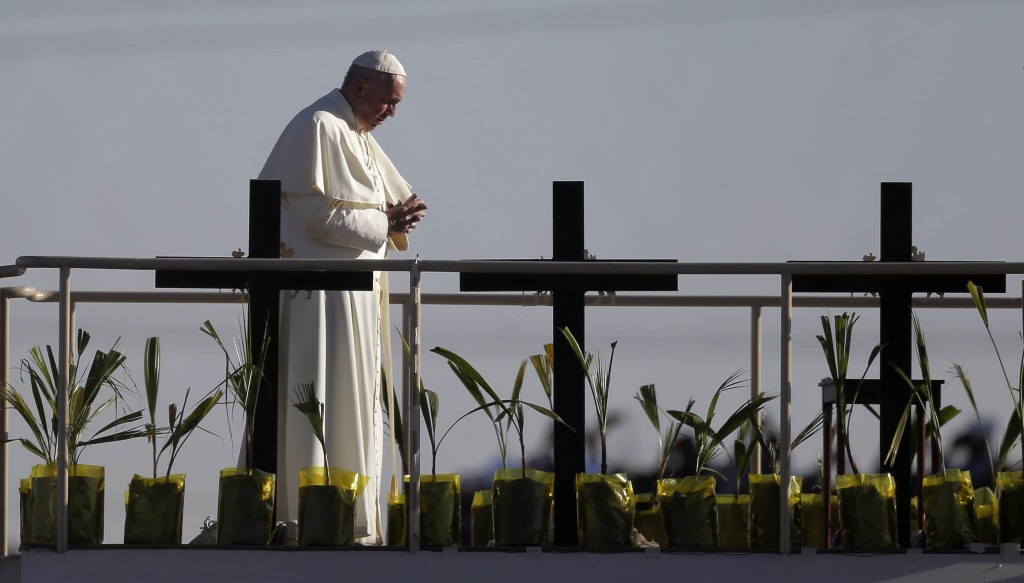 Pope Francis stands a platform near the U.S.-Mexico border fence along the Rio Grande, in Ciudad Juarez, Mexico, Wednesday, Feb. 17, 2016, as seen from in El Paso, Texas, Wednesday, Feb. 17, 2016. Francis made the sign of the cross and blessed hundreds of people gathered in El Paso. (AP Photo/Eric Gay)
