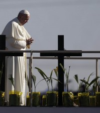 Pope Francis stands a platform near the U.S.-Mexico border fence along the Rio Grande, in Ciudad Juarez, Mexico, Wednesday, Feb. 17, 2016, as seen from in El Paso, Texas, Wednesday, Feb. 17, 2016. Francis made the sign of the cross and blessed hundreds of people gathered in El Paso. (AP Photo/Eric Gay)