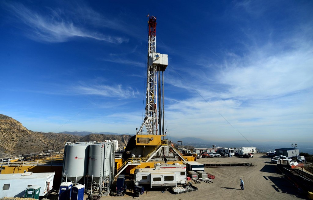 FILE - In this Dec. 9, 2015, pool file photo, crews work on stopping a gas leak at a relief well at the Aliso Canyon facility above the Porter Ranch area of Los Angeles.The utility says it has stopped the natural gas leak near Los Angeles after nearly 4 months. (Dean Musgrove/Los Angeles Daily News via AP, Pool, File)