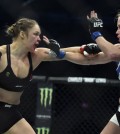 FILE - In this Sunday, Nov. 15, 2015 file photo, Ronda Rousey, left, and Holly Holm fight during their UFC 193 bantamweight title bout in Melbourne, Australia. Holm pulled off a stunning upset victory over Rousey in the fight, knocking out the women's bantamweight champion in the second round with a powerful kick to the head Sunday. Ronda Rousey says she had dark thoughts after she lost her bantamweight title to Holly Holm in Australia last year, her first defeat since joining UFC, Tuesday, Feb. 16, 2016. (AP Photo/Andy Brownbill, File)