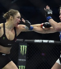 FILE - In this Sunday, Nov. 15, 2015 file photo, Ronda Rousey, left, and Holly Holm fight during their UFC 193 bantamweight title bout in Melbourne, Australia. Holm pulled off a stunning upset victory over Rousey in the fight, knocking out the women's bantamweight champion in the second round with a powerful kick to the head Sunday. Ronda Rousey says she had dark thoughts after she lost her bantamweight title to Holly Holm in Australia last year, her first defeat since joining UFC, Tuesday, Feb. 16, 2016. (AP Photo/Andy Brownbill, File)