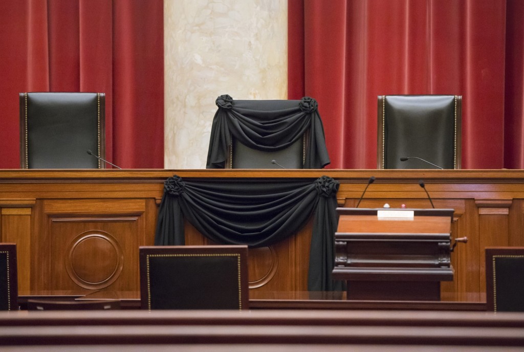 Supreme Court Justice Antonin Scalia’s courtroom chair is draped in black to mark his death as part of a tradition that dates to the 19th century, Tuesday, Feb. 16, 2016, at the Supreme Court in Washington. Scalia died Saturday at age 79. He joined the court in 1986 and was its longest-serving justice. (AP Photo/J. Scott Applewhite)