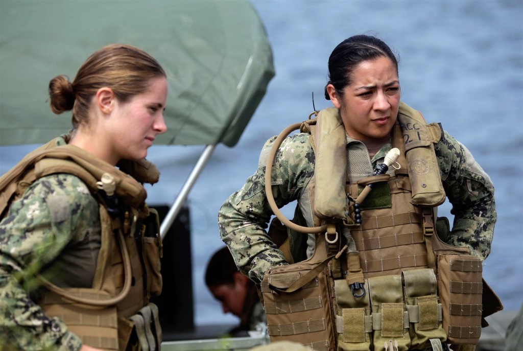 U.S. Navy Master-at-Arms Third Class Danielle Hinchliff, left, and Master-at-Arms Third Class Anna Schnatzmeyer listen during training in 2013. (Gerry Broome / AP, file)