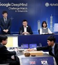 South Korean Go grandmaster Lee Se-dol (R) makes the first move in his highly anticipated showdown with the Google-developed supercomputer AlphaGo at the Four Seasons hotel in downtown Seoul on March 9, 2016, in this photo released by Google. (Yonhap)