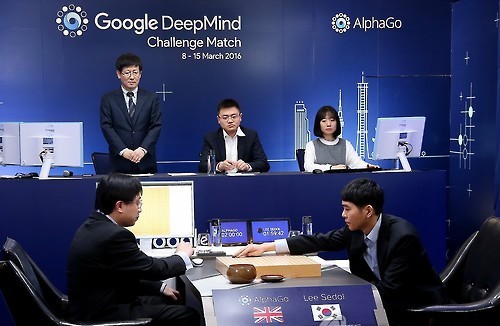 South Korean Go grandmaster Lee Se-dol (R) makes the first move in his highly anticipated showdown with the Google-developed supercomputer AlphaGo at the Four Seasons hotel in downtown Seoul on March 9, 2016, in this photo released by Google. (Yonhap)