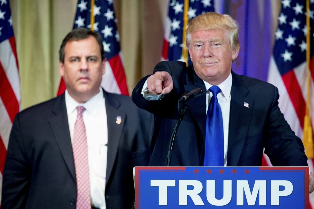 Republican presidential candidate Donald Trump, accompanied by New Jersey Gov. Chris Christie, left, takes questions from members of the media during a news conference on Super Tuesday primary election night in the White and Gold Ballroom at The Mar-A-Lago Club in Palm Beach, Fla., Tuesday, March 1, 2016. (AP Photo/Andrew Harnik)