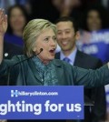 Democratic presidential candidate Hillary Clinton, center, speaks as Seattle Mayor Ed Murray, left, and his husband, Michael Shiosaki, right, look on Tuesday, March 22, 2016, during a campaign rally at Rainier Beach High School in Seattle. (AP Photo/Ted S. Warren)