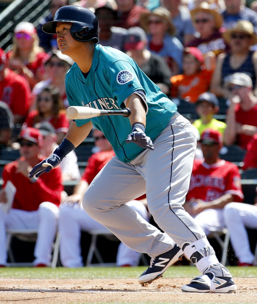 Seattle Mariners' Dae-Ho Lee follows through on an RBI base hit against the Los Angeles Angels during the first inning of a spring training baseball game, Tuesday, March 15, 2016, in Tempe, Ariz. (AP Photo/Matt York)