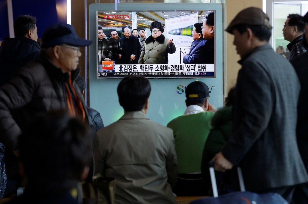 People watch a TV news program showing North Korean leader Kim Jong Un with superimposed letters that read: "North Korea has made nuclear warheads small enough to fit on ballistic missiles" at Seoul Railway Station in Seoul, South Korea, Wednesday, March 9, 2016. The official North Korean news agency says the communist country's leader Kim met his nuclear scientists for a briefing and declared he was greatly pleased that warheads had been miniaturized for use on ballistic missiles. (AP Photo/Ahn Young-joon)