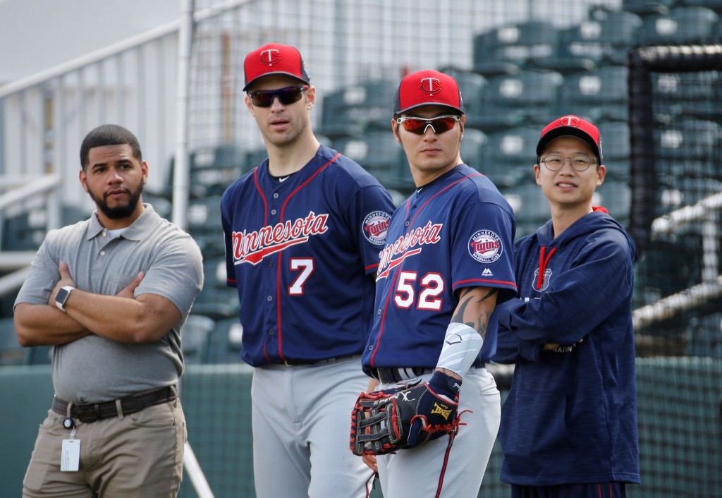 Minnesota Twins first baseman Joe Mauer (7) stands with teammate Byung Ho Park, of South Korea, during a spring training baseball workout in Fort Myers, Fla., Monday, Feb. 29, 2016. (AP Photo/Patrick Semansky)