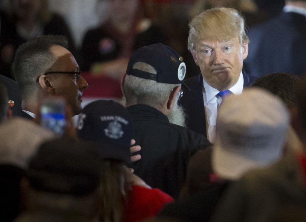 Republican presidential candidate Donald Trump reacts as veteran Keith Moppin asks the candidate to clarify comments he made about Arizona Sen. John McCain during a campaign stop at the Savannah Center, Sunday, March 13, 2016, in West Chester, Ohio. Trump said in July while campaigning in Iowa that he dismissed the notion that McCain, the 2008 Republican nominee for president, was a hero "Because he was captured." Trump said, "I like people who weren't captured." (AP Photo/John Minchillo)