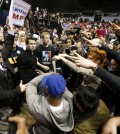 Supporters of Republican presidential candidate Donald Trump, left, face off with protesters after a rally on the campus of the University of Illinois-Chicago was cancelled due to security concerns Friday, March 11, 2016, in Chicago. (AP Photo/Charles Rex Arbogast)