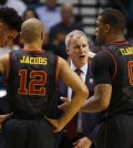 Southern California head coach Andy Enfield, second from right, speaks with forward Bennie Boatwright, left, guard Julian Jacobs, second from left, and Southern California forward Darion Clark during the second half of an NCAA college basketball game against Utah in the quarterfinal round of the Pac-12 men's tournament Thursday, March 10, 2016, in Las Vegas. Utah won 80-72. (AP Photo/John Locher)