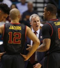 Southern California head coach Andy Enfield, second from right, speaks with forward Bennie Boatwright, left, guard Julian Jacobs, second from left, and Southern California forward Darion Clark during the second half of an NCAA college basketball game against Utah in the quarterfinal round of the Pac-12 men's tournament Thursday, March 10, 2016, in Las Vegas. Utah won 80-72. (AP Photo/John Locher)