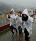 Three women run and laugh in the rain as they begin to cross the Golden Gate Bridge Thursday, March 10, 2016, in Sausalito, Calif. The ongoing deluge of storms in Northern California has swelled lakes and dams, boosting the prospects for outdoor recreation but likely falling short of ending the drought. Heavy rain hit the region north of San Francisco on Thursday with four inches expected by Friday, the National Weather Service said.(AP Photo/Eric Risberg)