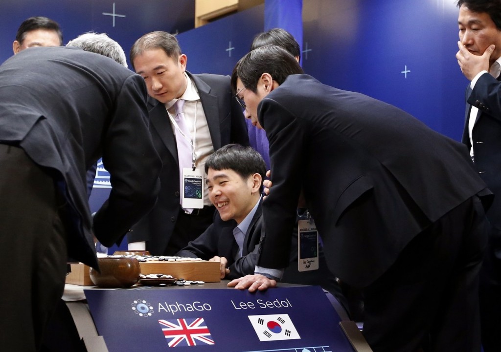 South Korean professional Go player Lee Sedol smiles as he reviews the match with other Go players after finishing the final match of the Google DeepMind Challenge Match against Google's artificial intelligence program, AlphaGo, in Seoul, South Korea, Tuesday, March 15, 2016. Google's Go-playing computer program again defeated its human opponent in the final match on Tuesday that sealed its 4:1 victory. (AP Photo/Lee Jin-man)