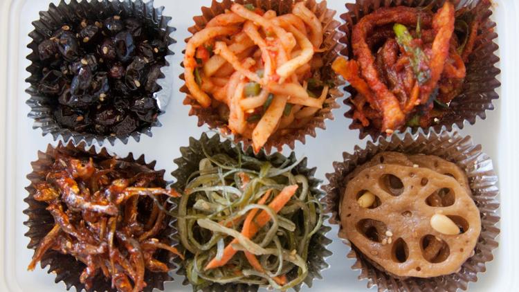 Shown is the Foodshop’s sampler box, with the banchan arranged in cupcake liners. (Cecilia Hae-Jin Lee / For the Los Angeles Times) 