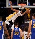 Los Angeles Lakers guard Jordan Clarkson, top, falls from the rim after a dunk during the second half of an NBA basketball game against the Golden State Warriors in Los Angeles, Sunday, March 6, 2016. The Los Angeles Lakers won 112-95. (AP Photo/Kelvin Kuo)