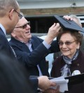 Donald Huston, center, puts a graduation cap on his mother, Dorothy L. Liggett as Akron Schools Superintendent David James, left, presents her belated North High School diploma on Wednesday, March 9, 2016, in Fairlawn, Ohio. Liggett was a few weeks from graduation from Akron's North High School in 1942 when officials discovered she was married. Liggett and her late husband, John Huston, ran away to Kentucky to get married after her husband was called into the U.S. Army Air Corps during World War II. (Michael Chritton/Akron Beacon Journal via AP)