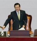 South Korean National Assembly Speaker Chung Ui-hwa bangs the gavel as he announces passing an anti-terror legislation during the plenary session at the National Assembly in Seoul, South Korea, Wednesday, March 2, 2016. Outnumbered South Korean opposition lawmakers on Wednesday ended more than a week of nonstop speeches in the National Assembly aimed at delaying a vote on the country's first anti-terror legislation. (Kim Hyun-tai/Yonhap via AP)