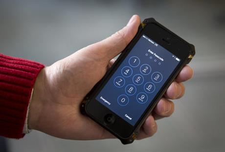 FILE - This Feb. 17, 2016 file photos an iPhone is seen in Washington. The dispute over whether Apple must help the FBI hack into a terror suspect's iPhone is about to play out in a Southern California courtroom. The hearing Tuesday, March 22, in U.S. District Court in Riverside is the first in the battle that has seen Cook and FBI Director James Comey spar over issues of privacy and national security. (AP Photo/Carolyn Kaster,File)
