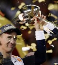 FILE - In this Feb. 7, 2016, file photo, Denver Broncos’ Peyton Manning holds up the trophy after the NFL Super Bowl 50 football game in Santa Clara, Calif. A person with knowledge of the decision tells The Associated Press on Sunday, March 6, 2016, that Manning has informed the Denver Broncos he's going to retire. The person, who was briefed on the matter, spoke to The AP on condition of anonymity because the quarterback and the team were still working out details of an announcement. (AP Photo/Matt York, File)
