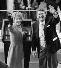 FILE - In this Jan. 20, 1981, file photo, President Ronald Reagan and first lady Nancy Reagan wave to onlookers at the Capitol building as they stand at the podium in Washington following the swearing in ceremony. The former first lady has died at 94, The Associated Press confirmed Sunday, March 6, 2016. (AP Photo/File)